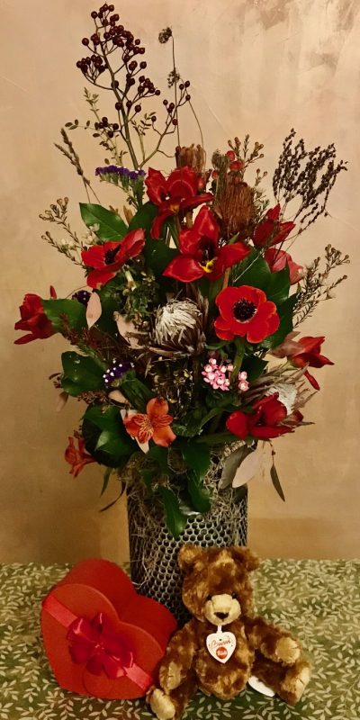 Composizione di fiori con orsetto e vaso in ceramica